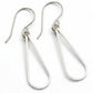 Pair of silver teardrop earrings on a gray background