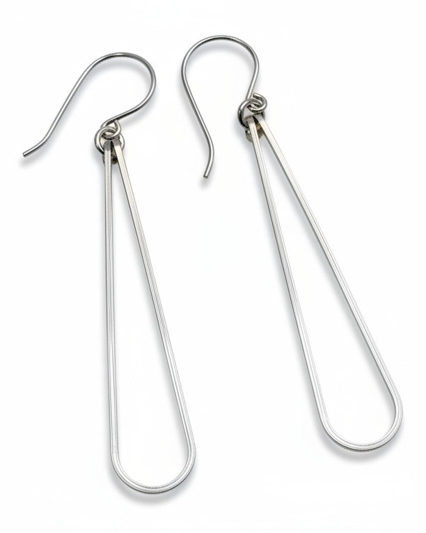 Pair of silver teardrop earrings on a gray background