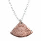 Copper pendant necklace on a light gray background