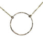 Silver circular pendant on a chain against a gray background