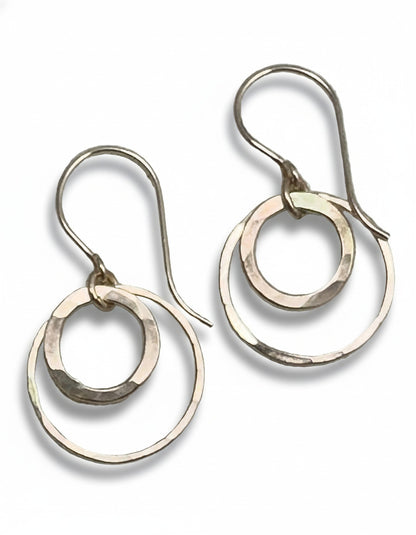 Silver hoop earrings on a textured gray background