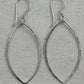 Pair of silver hoop earrings on a textured gray background