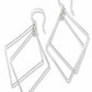 Pair of silver geometric earrings on a textured beige background
