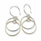 A pair of earrings featuring sterling silver and 14K gold-filled wire in a double circle design.