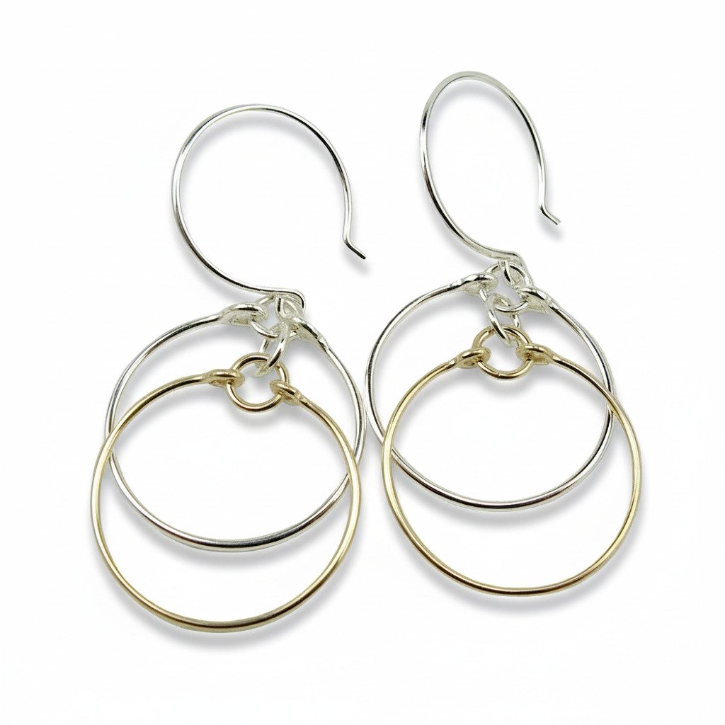 A pair of earrings featuring sterling silver and 14K gold-filled wire in a double circle design.