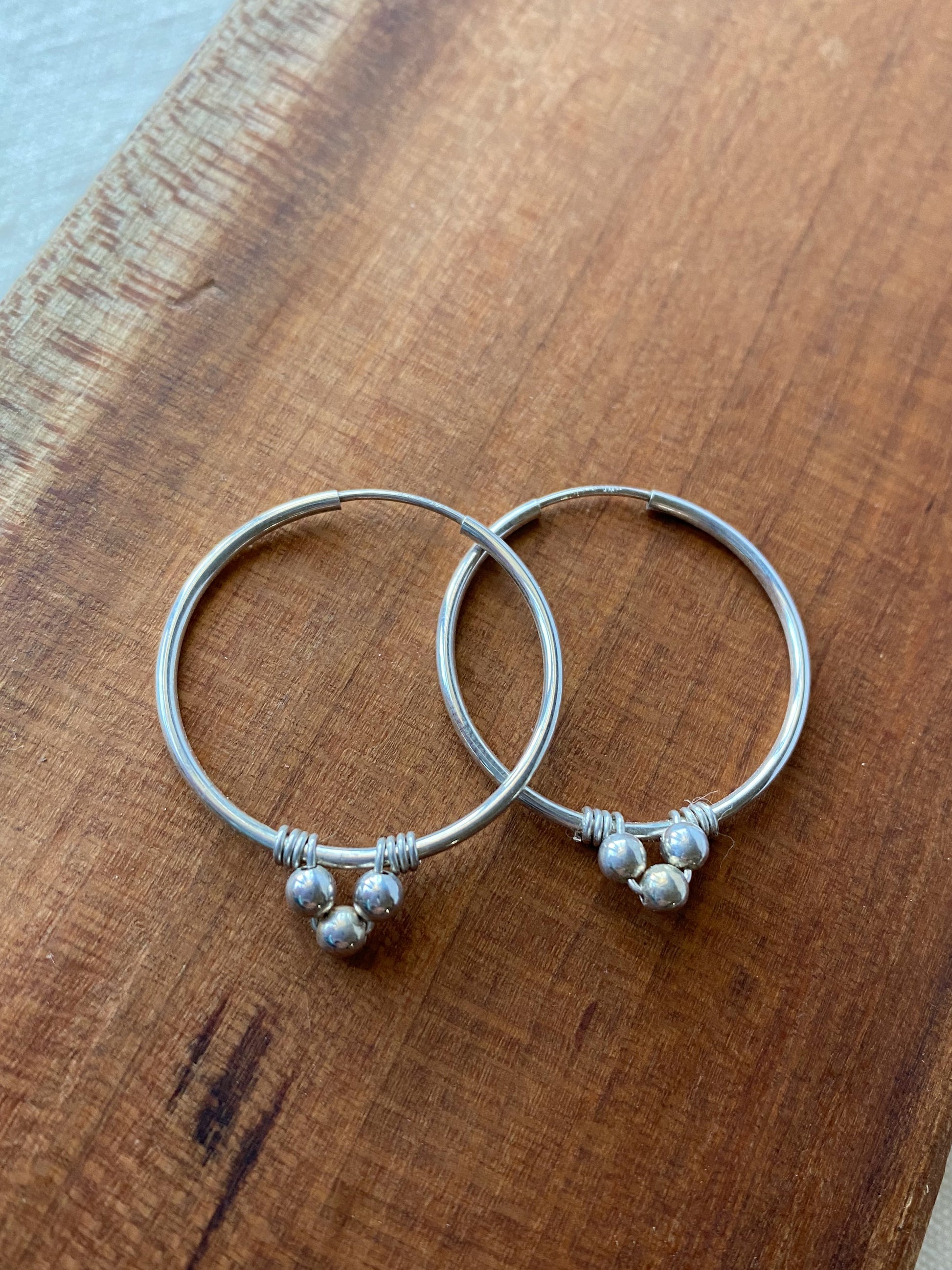 Endless Silver Hoop Earrings with Bead Accents - Cloverleaf Jewelry