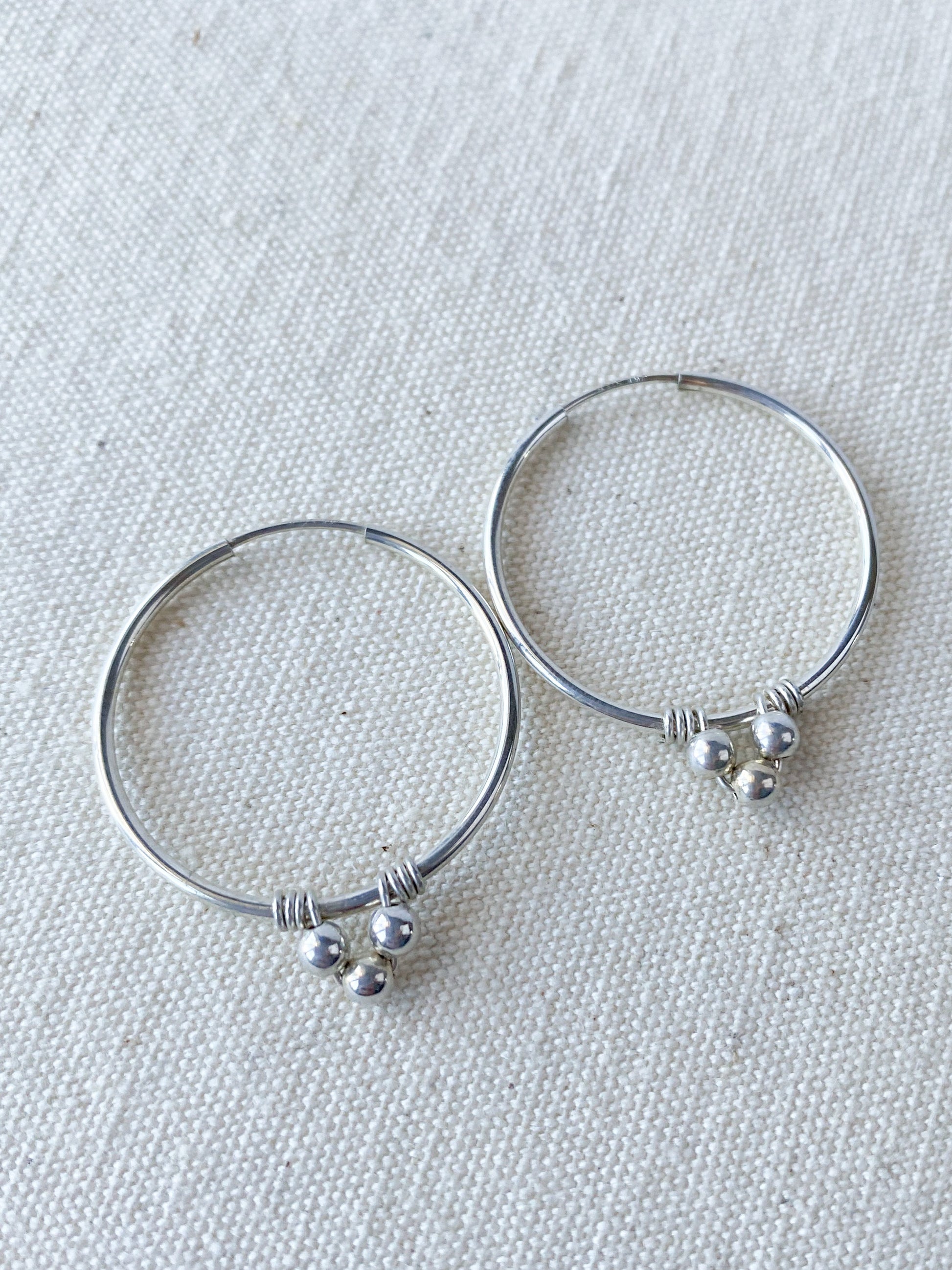Endless Silver Hoop Earrings with Bead Accents - Cloverleaf Jewelry